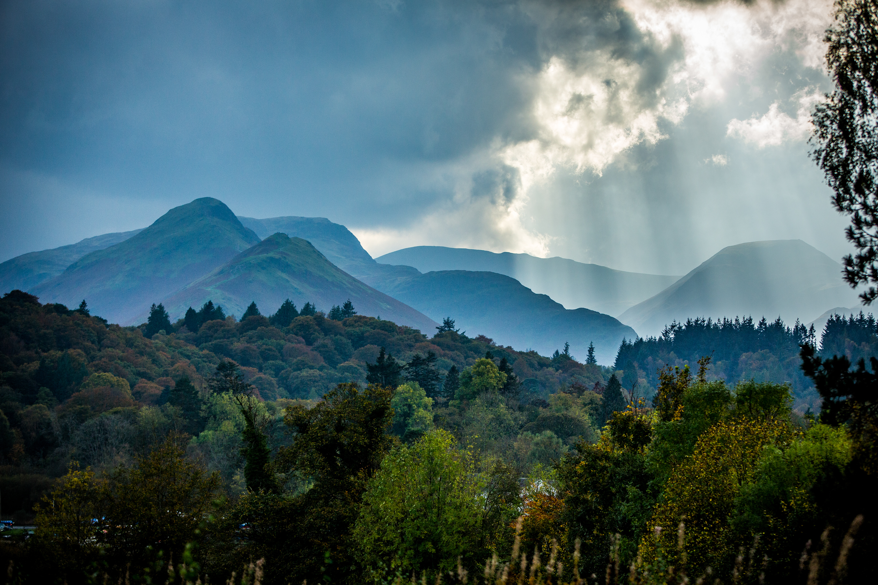 Sun rays breaking through and lighting up the Lake District mountains